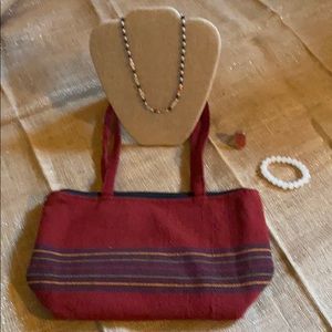 A necklace, purse, ring and bracelet.